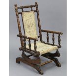 An early 20th century beech child’s rocking chair with padded seat & back, on American-style
