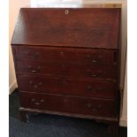 A 19th century oak bureau with fitted interior enclosed by fall-front above four long graduated