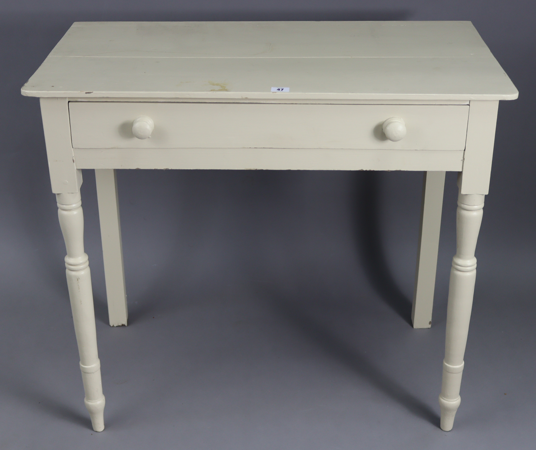 A white painted pine side table, fitted frieze drawer & on turned tapered legs, 33½” wide x 29½”