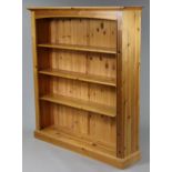 A pine four-tier standing open bookcase on a plinth base, 50” wide x 56” high x 11¾” deep.