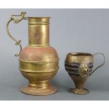 A Victorian copper & brass flagon in the medieval style, with scroll handle & on circular base,