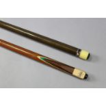 An Olympus club two-piece snooker cue; & another two-piece snooker cue.