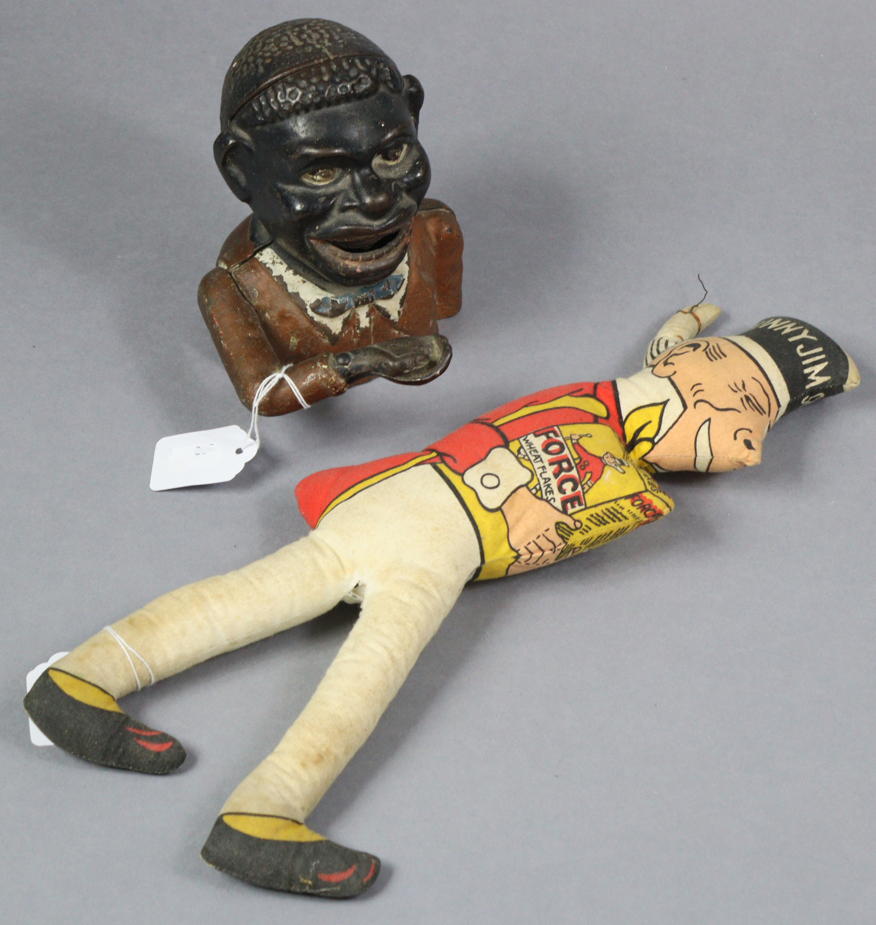 A 1930’s “Sunny Jim” Wheat Flakes advertising doll, 16” tall; & a painted cast-iron “Jolly Nigger”