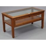 A Chinese rosewood display-top coffee table inset plate-glass to the rectangular top, enclosed by