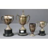 Four various silver two-handled trophy cups.