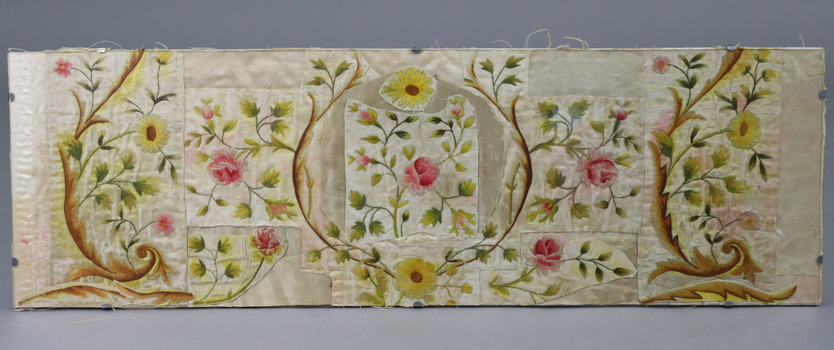 A silk embroidered floral panel made from a vintage gent's waistcoat, 11¼" x 35½", in a glazed