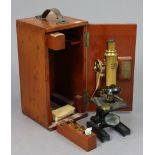 An early 20th century Ross of London brass monocular microscope (No. 8734), with mahogany case.