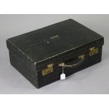 A late 19th/early 20th century dark green finish crocodile-skin suitcase with brass twin-lever