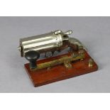 A novelty silvered-metal dispenser in the form of a revolver, 5½” wide; & a Morse-code tapper, 5”