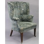 A 19th century armchair, with buttoned tall rounded back & spring seat upholstered grey & ivory