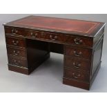 A reproduction mahogany pedestal desk, inset gilt-tooled crimson leather & fitted with an