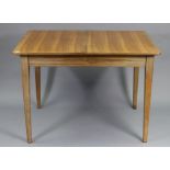 A GORDON RUSSELL OF BROADWAY WALNUT EXTENDING DINING TABLE with moulded edge to the rectangular top,