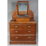 A late Victorian walnut dressing chest with rectangular swing mirror to the stage back, fitted two