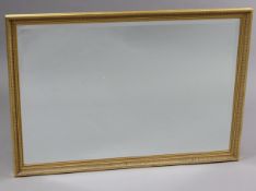 A large gilt-frame rectangular wall mirror with fluted border & inset bevelled plate, 26¼” x 37¾”.