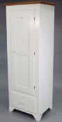 A white-finish & natural wood tall cupboard with three adjustable shelves enclosed by a panel
