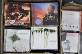 A collection of assorted CDs, DVDs, & records.
