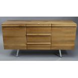 A teak sideboard (purchased from Silcox Son & Wicks of Bath), fitted three long drawers to centre
