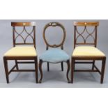 A pair of inlaid-mahogany bow-back dining chairs with padded drop-in seats, on fluted square tapered