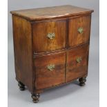 A Georgian-style small mahogany bow-front cabinet with hinged lift-lid, fitted a long drawer above