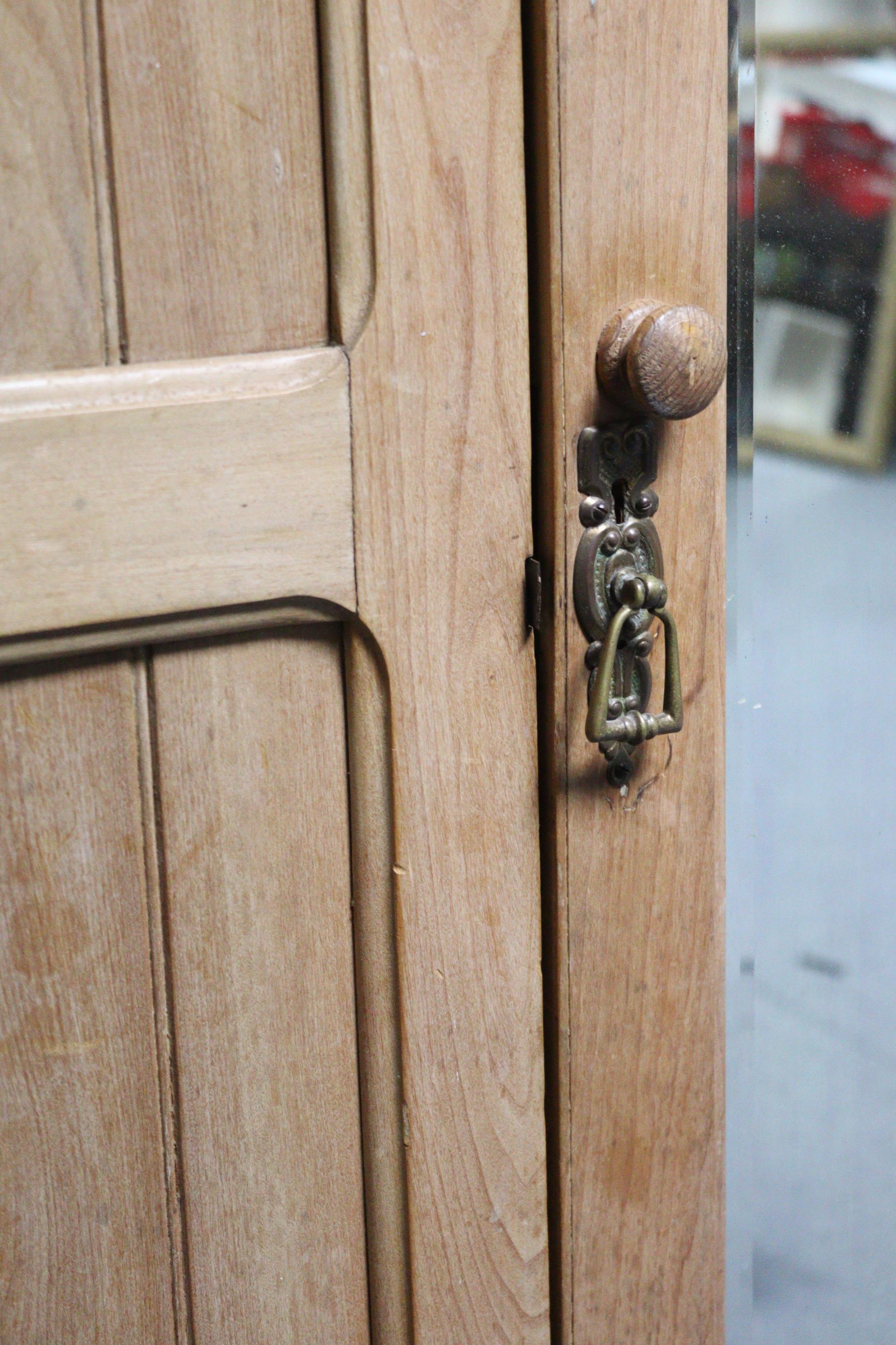 A late Victorian bleached walnut wardrobe with moulded cornice, enclosed by a rectangular bevelled - Image 2 of 9