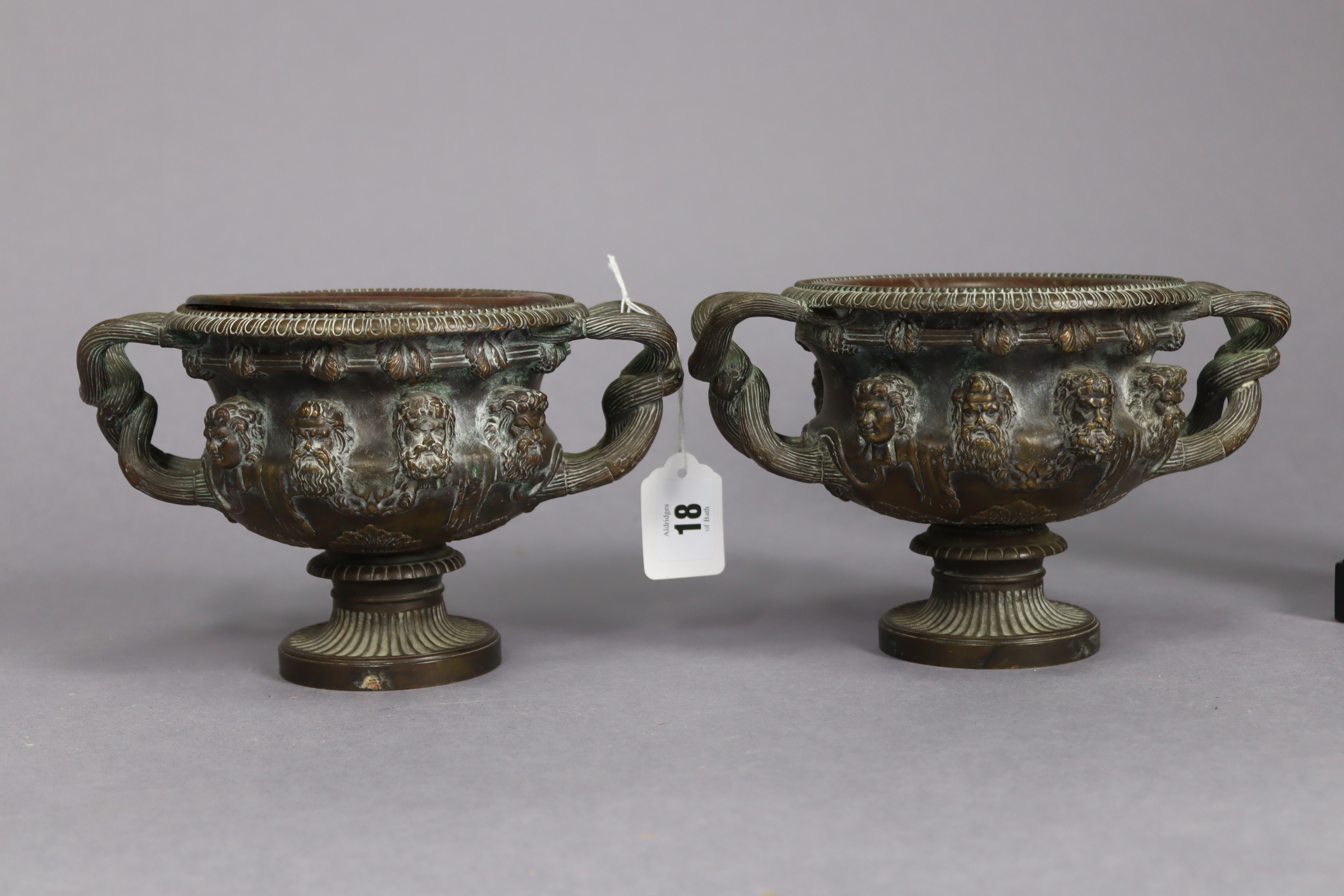 A pair of bronzed circular two-handled vases each with raised mask design & on a round pedestal - Image 3 of 6
