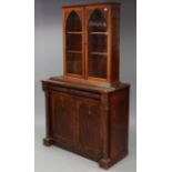 A Victorian mahogany bookcase base fitted two cushion-fronted frieze drawers above cupboard enclosed