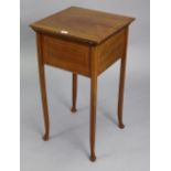 An Edwardian inlaid-mahogany needlework table with hinged rectangular top, & on four slender legs,