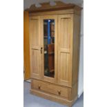 A late Victorian bleached walnut wardrobe with moulded cornice, enclosed by a rectangular bevelled