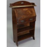 An Edwardian oak small upright bureau with fitted interior enclosed by a fall-front above a long