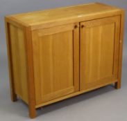 A LAURA ASHLEY LIGHT OAK CUPBOARD, fitted centre shelf enclosed by a pair of panel doors, 39¼”