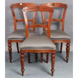 A set of three late 19th century beech balloon-back dining chairs with padded seats, & on ring-