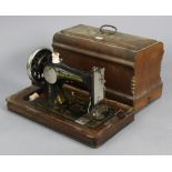 A vintage Frister & Rossman hand sewing machine with wooden case.