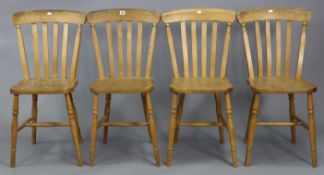 A set of four lath-back kitchen chairs with hard seats, & on turned legs with spindle stretchers.