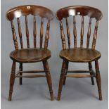 A pair of spindle-back kitchen chairs with circular hard seats, & on ring-turned legs with spindle
