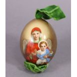 A RUSSIAN IMPERIAL PORCELAIN EASTER EGG, painted with the Virgin Mary & Infant Christ on a gilt