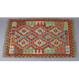 A Choli kilim rug, with all-over repeating multicoloured geometric design within a narrow border,