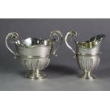 A Victorian silver semi-fluted helmet shaped cream jug & matching two-handled sugar bowl in the