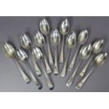 Twelve George III silver Old English table spoons; & a William IV ditto – odd dates & makers. (