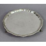 A late Victorian silver salver with shaped & raised gadrooned border, on three pad feet, 12.25”