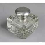 An Edwardian square glass silver-mounted inkwell with canted corners & hobnail base, the hinged