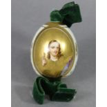A Russian Imperial Porcelain easter egg painted with a portrait of Christ on a gilt ground