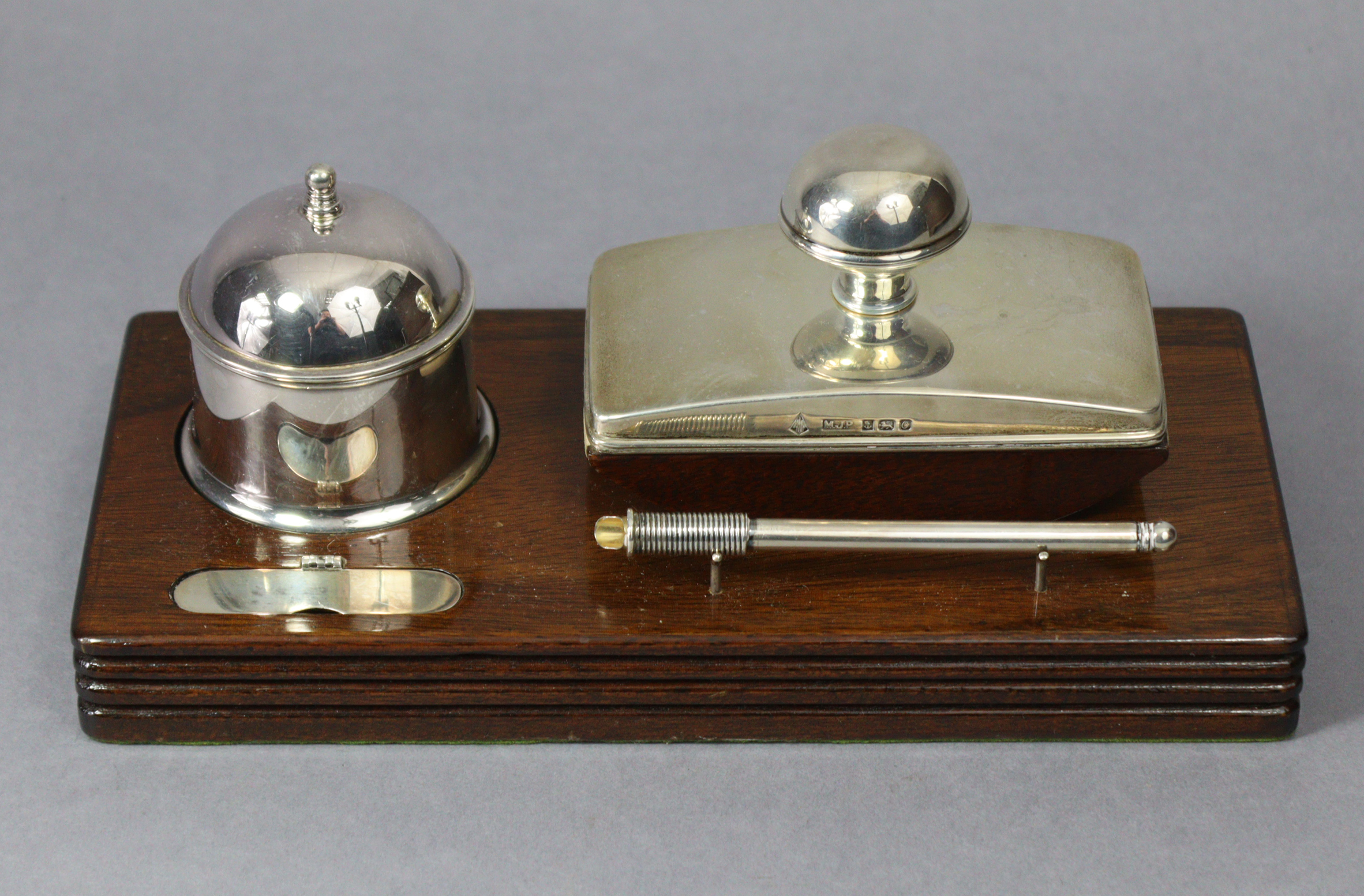A contemporary silver desk set by Martyn Pugh of Redditch, comprising a cylindrical inkwell with