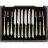 Six pairs of dessert knives & forks with silver-gilt & green enamel Lotus pattern handles (