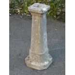 A composition stone tapered pedestal/bird-bath stand with foliate decoration, on canted square