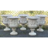 A SET OF FIVE COMPOSITION STONE NEO-CLASSICAL STYLE GARDEN URNS, of campana form with relief