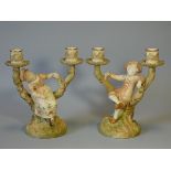 A pair of Royal Worcester porcelain rustic twin-branch candelabra with Kate Greenaway style boy &