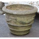 A large stone garden pot with ribbon-bow & swag decoration, 30” wide x 24” high.