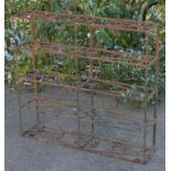 A wrought iron garden plant stand or etagere of five tiers, with pierced scroll decoration; 43” wide