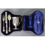 A Victorian silver christening set comprising an engraved mug with rounded base, lobed handle, &
