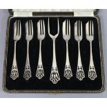 A set of six George V silver cake forks & matching serving fork with pierced stylised floral